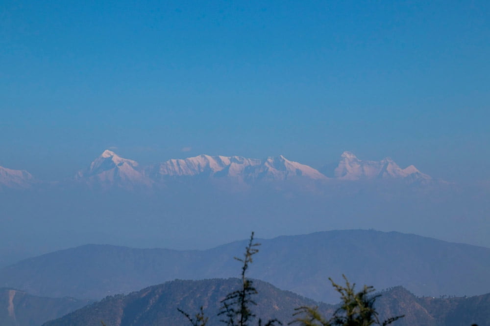 Spectacular snowy panorama as seen from Snow View Point, with Nainital's landscape stretching below.